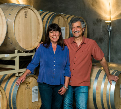 Jonathan and Susan with wine barrels